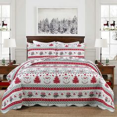 a bed covered in a red and white christmas themed comforter next to two windows