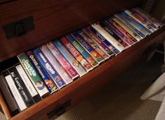 there is a drawer with many movies on it and the drawers are open to show them