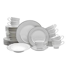 a stack of white dishes with cups and saucers on top of each other in front of a white background