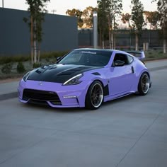 a purple sports car parked in front of a building