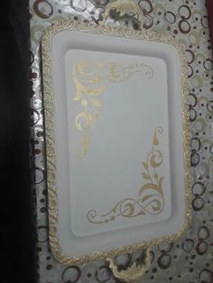 an ornate white and gold card holder