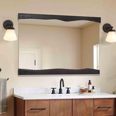 a bathroom vanity with a large mirror above it