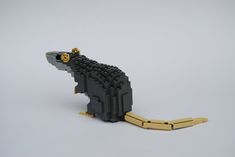 an animal made out of legos on a white surface