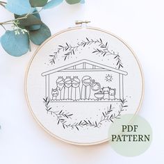 a cross stitch pattern with a nativity scene in the hoop on a white background