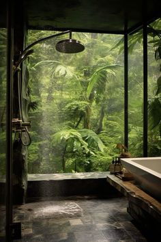 a bath room with a large window and a tub in front of the shower head