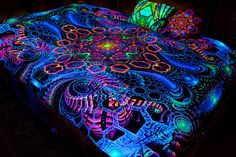 a lit up bed with an intricate design on it