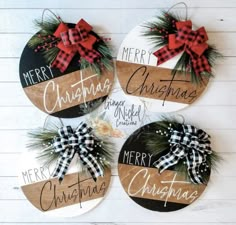 three wooden christmas ornaments with bows and pine cones on them, hanging from the wall