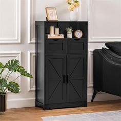 a black cabinet with doors and drawers in a living room