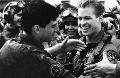 black and white photograph of two men in pilot's gear talking to each other