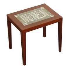 a small wooden table with tile on the top and bottom part inlayed to it