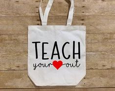 a tote bag with the words teach your heart out on it and a red heart