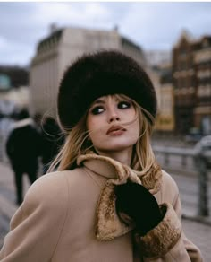 a woman wearing a fur hat and scarf