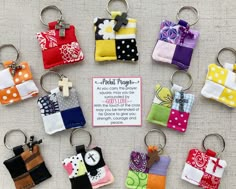 a bunch of small pieces of fabric hanging from key chains