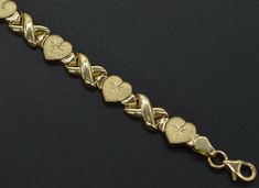 This 10k Solid Yellow Gold Hearts & Kisses Bracelet 71/2'' 8mm 5.1gr is ideal for the classic lady with a keen sense of style. With a fantastic style and color pick the design that best fits you. Here's a lovely heart-link bracelet that expresses heartfelt sentiments! A delightful heart-shaped bracelet is understated and perfect for wearing your heart on your sleeve every day and for special occasions. Specifications: Gold Weight: 5.1 grams Metal Type: 10K Solid Gold Bracelet Length: 7.5 inches Wedding Yellow Gold Plated Heart Bracelet, Heart-shaped Yellow Gold Bracelets For Wedding, Yellow Gold Heart Bracelet For Valentine's Day, Luxury Yellow Gold Elegant Heart Bracelet, Heart-shaped Yellow Gold Bracelet Gift, Valentine's Day Yellow Gold-plated Heart Bracelet, Gold Arm Band, Solid Gold Bracelet, Gold Hearts