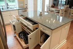 an open drawer in the middle of a kitchen