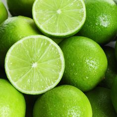 several limes with one cut in half and the other whole on top of each other