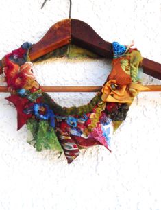 a multicolored scarf hanging on a wooden hanger