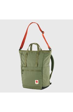 a green backpack with red straps hanging from the front and side pockets on each side