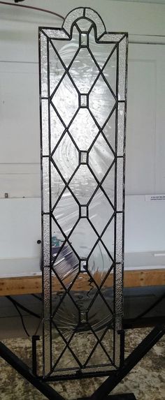 a glass window sitting on top of a metal stand