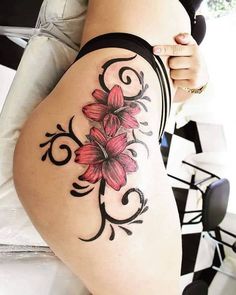 a woman's thigh with flowers on it