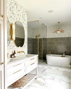 a bathroom with two sinks and a bathtub next to a walk - in shower