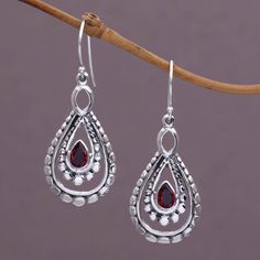 A pear-shaped garnet glistens at the heart of each of these dazzling dangle earrings. Using a combination of handmade and casting techniques artisan Nyoman Rena of Indonesia crafts the earrings from sterling silver. Teardrop Garnet Silver Jewelry, Teardrop Garnet For Jewelry Making, Garnet Teardrop Jewelry With Matching Earrings, Pear-shaped Teardrop Earrings As Gift, Teardrop Garnet Jewelry For Anniversary, Garnet Teardrop Earrings, Paw Print Jewelry, Ribbon Jewelry, Printed Jewelry