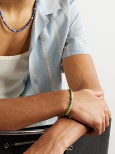 Inspired by its founder's love for travel, M. Cohen's jewellery draws on cultures from all over the world. Crafted by hand, this 'Rizon' bracelet is strung with sterling silver discs and vinyl beads, inspired by those once used as currency in parts of Africa, their colour is also used to signify emotions. It looks great layered as part of a stack. Tom Ford Bag, Sterling Silver Bead Bracelet, Jewelry Drawing, Silver Bead Bracelet, Mens Green, Fine Jewelry Designers, Cord Bracelets, Green Man, Black Vinyl