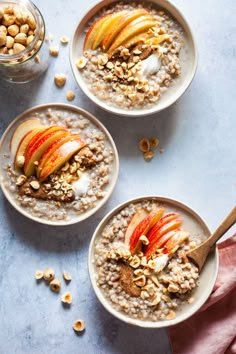 three bowls of oatmeal with apples and nuts