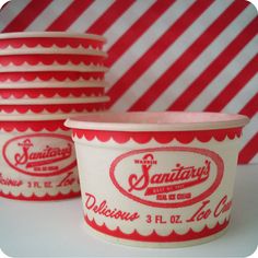 red and white striped paper cups are stacked on top of each other