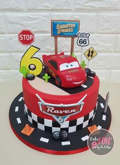 a birthday cake with cars on the top