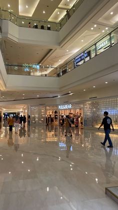 people are walking through an airport lobby