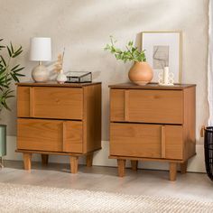 two wooden dressers sitting next to each other on top of a carpeted floor