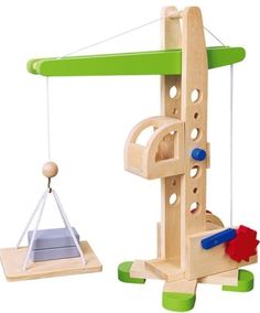 a wooden toy with a green top and white base holding a piece of wood in the shape of a crane