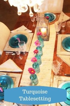 the table is set with blue plates and place settings