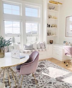 a living room filled with lots of furniture next to two windows and a rug on the floor