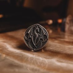 Mythical Winged Dragon Signet Ring in 925 Sterling Silver, Oxidized Statement Ring for Him, Mythology Ring Boyfriend, Cool Biker Jewelry * Gender : Female & Male     *  Stamp: 925 Sterling Silver  * Finish: Oxidized - Polished - Gold Plated - PRODUCT DETAILS - * Ring Diameter: 2,30 Cm ( 0,91 Inches ) * Ring Weight: 11-12 Grams * Ring Size: 5 US to 15 US  ADVICES  '' * All our products are handmade and weights may vary  (-) 1,00 gram ( For USA Ring Size 11 ) * We recommend using the oxidized version of it. Also, the photos are of the oxidized version of the ring * If you want to have Solid Gold, please don't hesitate to contact us about our perfect price offers * Ring Size: 5 US to 15 US - ( Contact me if you're expecting to buy another ring size ) * RETURNS, EXCHANGES & CANCELLATIONS * * R Gothic Silver Stainless Steel Ring, Gothic Sterling Silver Rings For Gift, Gothic Stainless Steel Ring As A Gift, Handmade Gothic Ring As A Collectible, Gothic Engraved Rings For Anniversary, Sterling Silver Symbolic Snake Ring Collectible, Collectible Symbolic Sterling Silver Snake Ring, Sterling Silver Snake Ring Collectible Symbolic, Gothic Engraved Ring Jewelry