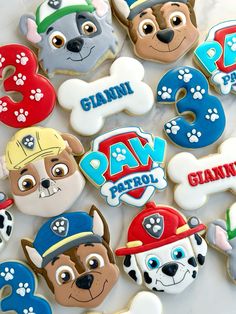 paw patrol birthday cookies are arranged on a table with the numbers 3, 5, and 8