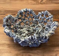 a blue and white bowl sitting on top of a wooden table