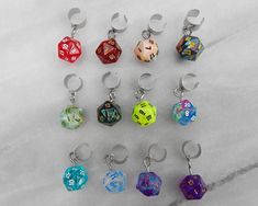 🎲 Carry your love of gaming with you wherever you go when you wear these mini D20 polyhedral dice ear cuffs! Available in a range of colors, they are very lightweight and require no piercing. These are the perfect cute and funky accessory for game night, cons, or wherever you feel like showing off your love of gaming and dice. 🎲 Please choose your color preference from the variation drop down box. If the color you want is not available, contact me for future availability. 🎲 Want a different t Dnd Jewelry, Geek Earrings, Ear Cuff Chain, Wrap Earrings, Funky Earrings, Polyhedral Dice, Satin Bags, Ear Cuffs, Delicate Jewelry