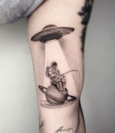 a man with a tattoo on his arm is flying through the sky above an object