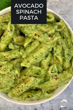 a white bowl filled with green guacamole and topped with red chili sprinkles