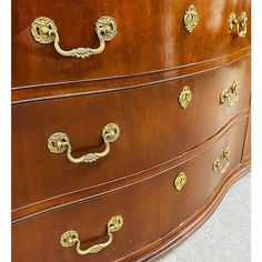 a large wooden dresser with gold handles and knobs