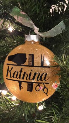 a christmas ornament hanging from a tree with the name kahrina on it