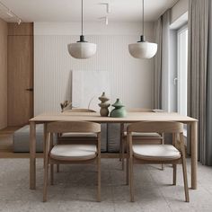 a dining table with four chairs and two vases on the table next to it