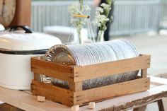 a wooden box with some kind of thing inside of it on a table next to other items