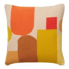 an orange, yellow and white pillow with circles on the front is featured in this image