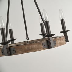 a wooden chandelier with six lights hanging from it