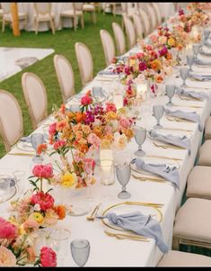 a long table is set with flowers and candles