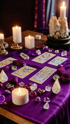 a table topped with lots of different types of candles and cards on top of it