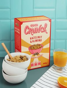 cereal and orange juice on a table next to a carton of cereal with an orange slice